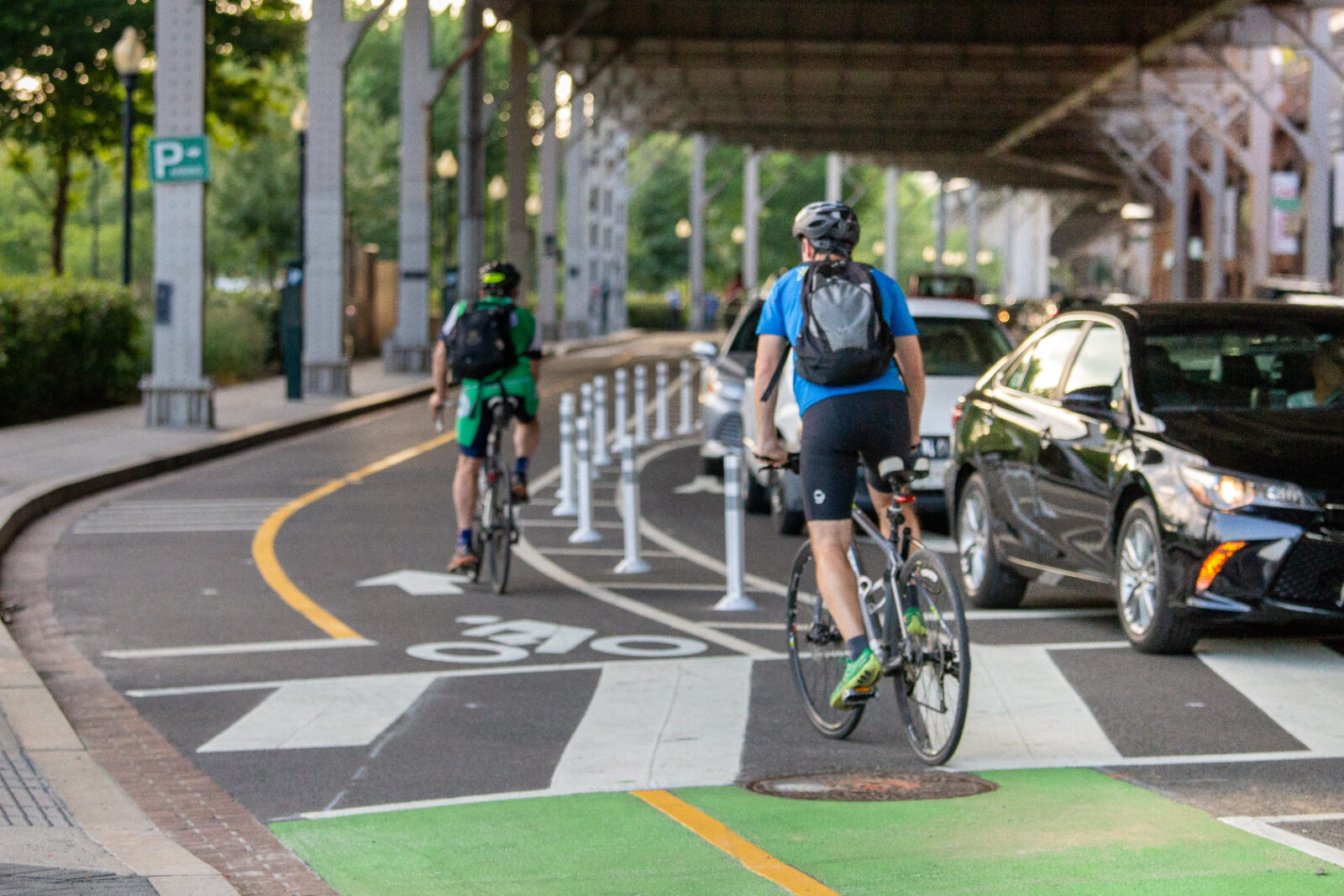 Cyclists biking against traffic in protected bike lane.